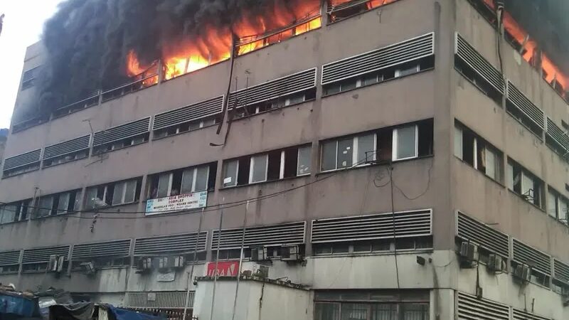Lagos fires at Afriland Towers and Mandilas Market showing smoke and firefighters